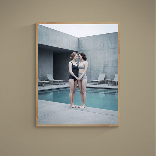 Framed poster of two women in vintage swimwear beside a turquoise brutalist concrete pool