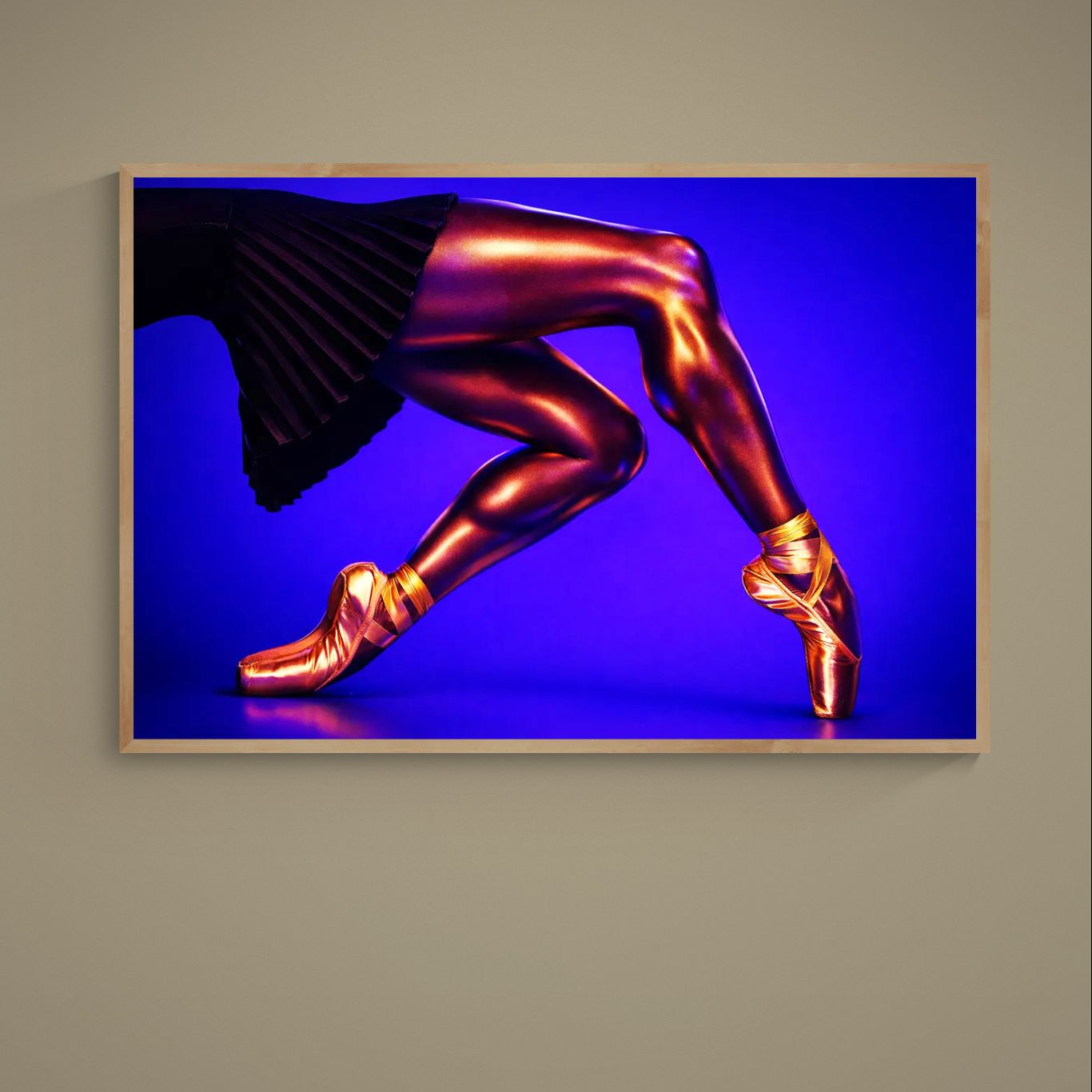 Close-up ballet poster of gold-orange ballerina legs en pointe on deep blue with black skirt
