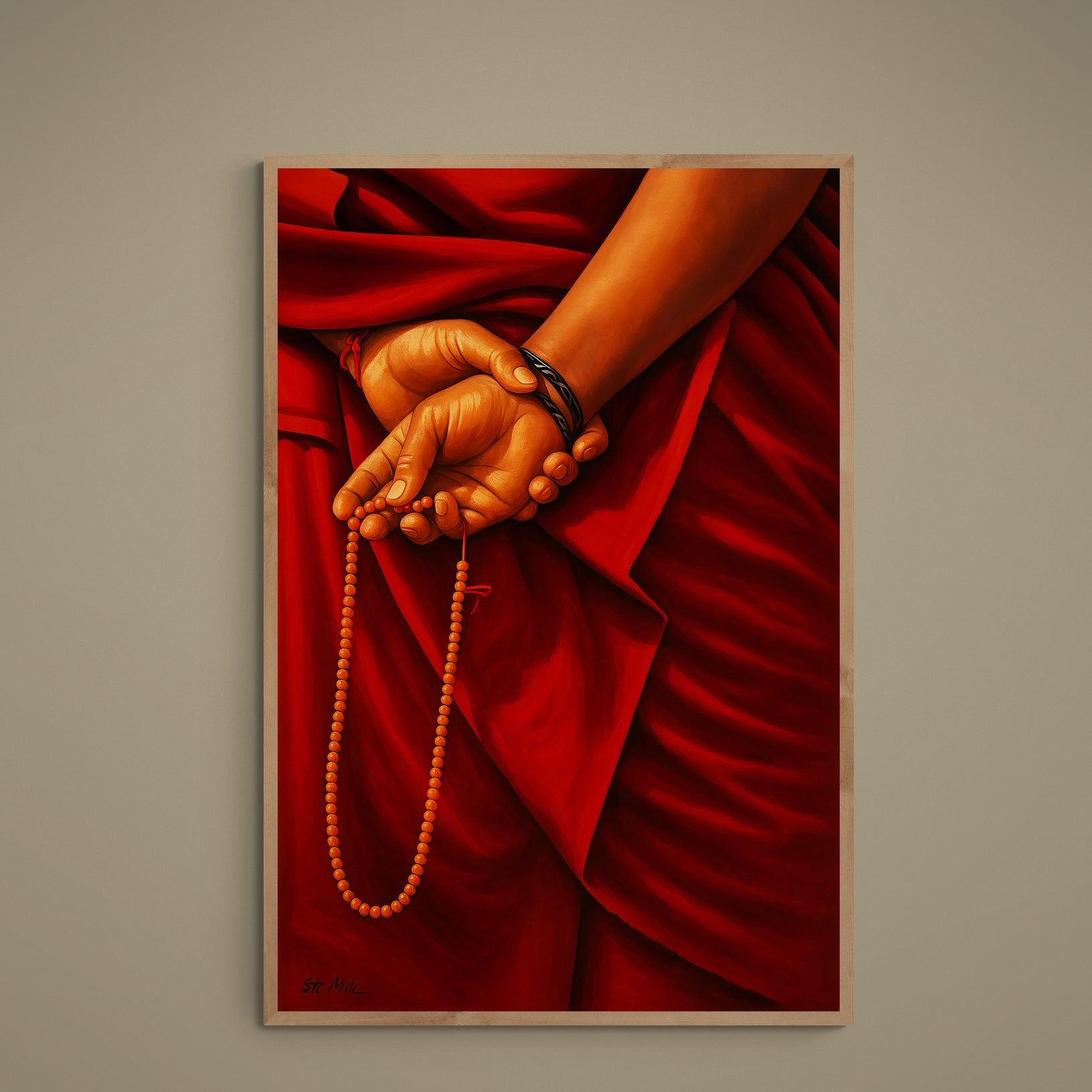 Close-up of monk's hands holding orange mala beads against deep red burgundy robes