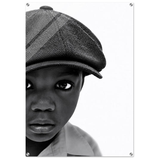 Monochrome acrylic wall art print featuring a boy in a flat cap, high-contrast black and white portrait.